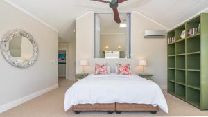 a bedroom with a large bed and a mirror at Narnia on Thesen Island in Knysna +23 photos