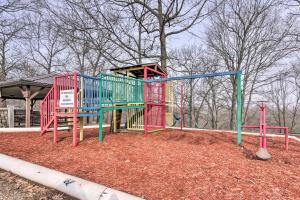 a playground in a park with a play structure at Family-Friendly Condo 1 Mi to Silver Dollar City! in Branson West