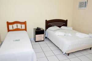 En eller flere senge i et værelse på Natal Palace Hotel
