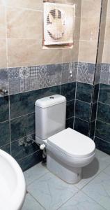 a bathroom with a toilet and a fan on the wall at Mama Africa in Hurghada +59 photos