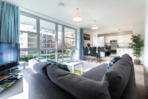 a living room with a large couch and a tv at Smart Apartments - Empress Heights in Southampton