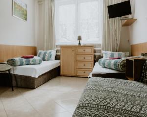 a bedroom with a bed and a dresser at Camping nr 61 in Elblag