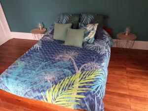 uma cama com um edredão colorido e almofadas em La Caudalie 