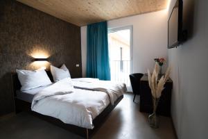 a hotel room with a bed and a window at Motel Q in Rottweil