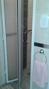 a shower with a glass door with a towel at NEFERET Habitaciones Temporarias in Corrientes