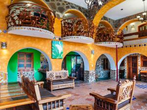 a large room with arches and chairs and chandeliers at Casa Miguel Arcangel in Coatepec