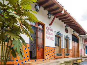a building with orange and blue tiles on it at Casa Miguel Arcangel in Coatepec