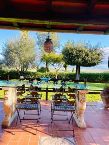 a stone table and chairs on a patio at villa porta a colle in Castiglione della Pescaia