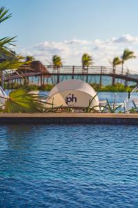 a pool at the end of a resort at Planet Hollywood Cancun, An Autograph Collection All-Inclusive Resort in Cancún
