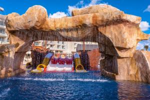 a water slide in a water park with a waterfall at Planet Hollywood Cancun, An Autograph Collection All-Inclusive Resort in Cancún