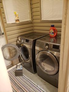 a washer and dryer in a corner of a room at MemeTori Cozy Vacation House in Hinton