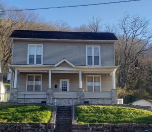 a gray house with a staircase in front of it at MemeTori Cozy Vacation House in Hinton