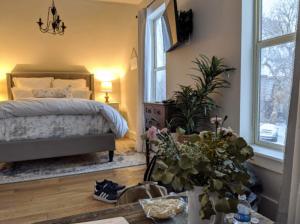 a bedroom with a bed and a table with flowers at The Farmhouse Inn & Kitchen, 2 blocks from Downtown Whitefish, Montana in Whitefish