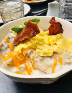 a plate of food with scrambled eggs and bacon at The Farmhouse Inn & Kitchen, 2 blocks from Downtown Whitefish, Montana in Whitefish