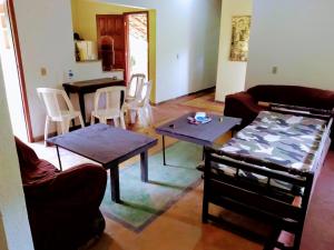 a living room with two tables and a couch at Casa da cachoeira na beira do Rio Sana in Sana
