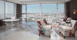 a large room with chairs and tables and windows at Quartier San Telmo Luxury Pool Gym & Spa, piscina climatizada in Buenos Aires