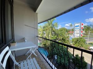 a balcony with a table and chairs and a view at Residential two bedroom, self-contained, renovated apartment, Sheridan St, self check-in in Cairns
