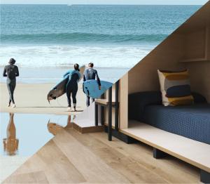 a group of people standing on the beach with surfboards at TAKE SURF Hostel Conil in Conil de la Frontera