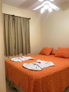a bedroom with two beds with white clothes on them at Complejo Bahia Ballenas in Rawson