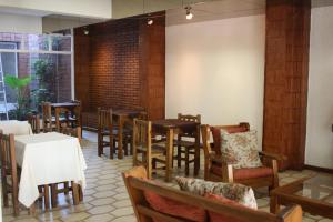 a dining room with wooden tables and chairs at Hotel Catedral San Rafael in San Rafael