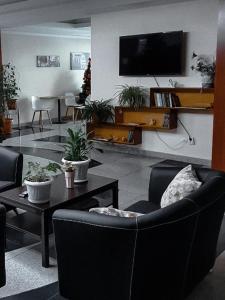 a living room with chairs and a flat screen tv at Отель Транзит in Pervomayskīy