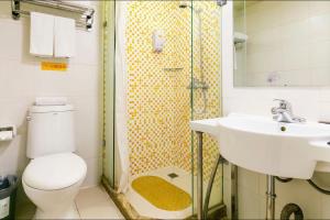 a bathroom with a toilet and a sink and a shower at Home Inn Xi'an South Taihua Road Daming Palace Relics Park in Xi'an
