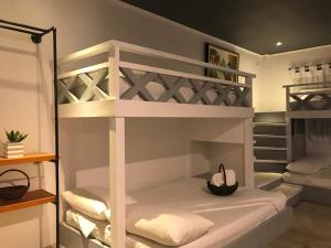 a room with two bunk beds with a hat at PAYAG SUITES in General Luna