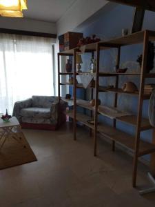 a living room with a book shelf and a couch at Between the Airport and the Harbour in Mytilene