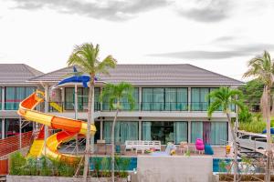 a slide in front of a house with a playground at Smart home huahin in Hua Hin