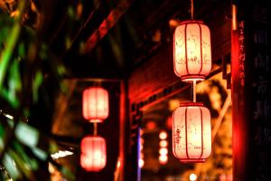 a group of red lanterns hanging from a building at Wenjun Courtyard Hotel ---5 mins walk from Tonghuimen metro station, near Tianfu square, close by culture park and Sichuan opera house, English speaking service, local tours in Chengdu