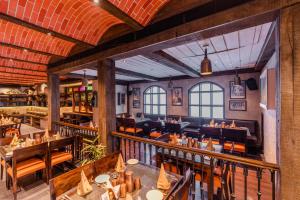a restaurant with wooden tables and chairs in a room at Regenta Inn Jaipur, Adarsh Nagar in Jaipur