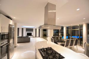 a kitchen and living room with a stove top oven at Villa Ahiska in Kalkan