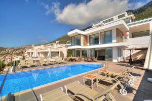 a villa with a swimming pool and a house at Villa Ahiska in Kalkan
