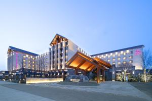 a large building with a sculpture in front of it at Crowne Plaza Beijing Badaling, an IHG Hotel in Yanqing