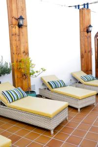 a group of beds sitting on a patio at El Charco Suites in Arrecife