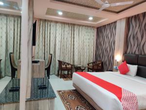 a hotel room with a bed and a table at Hotel Vip Square in Puri