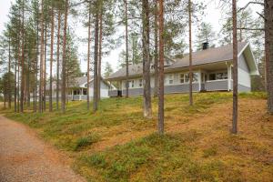 a house in the middle of a forest at Holiday Club Kuusamon Tropiikki Apartments in Kuusamo