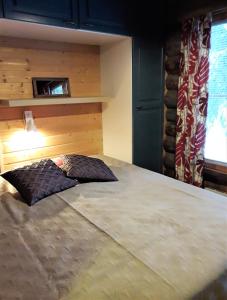 a bedroom with a large bed with a pillow on it at Salmikangas G4 in Ruka