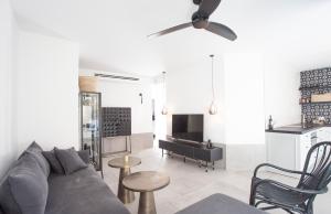 a living room with a couch and a table at Etis garden seafront in Haifa