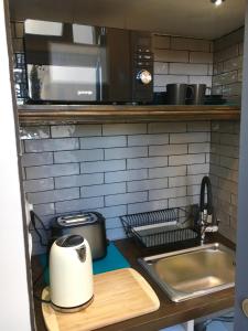 a kitchen with a sink and a microwave at Room eleven in Veliko Tŭrnovo