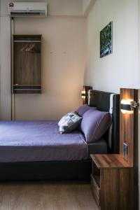 a bedroom with two beds and a table and a window at Step-in Lodge in Kota Kinabalu