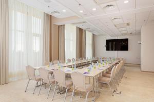 a large conference room with a long table and chairs at Omega Sirius in Adler