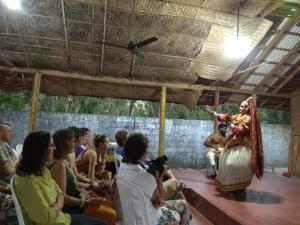 a group of people watching a woman on a stage at SAMBODHI YOGA RETREAT in Alleppey