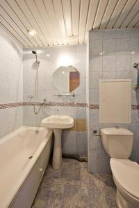 a bathroom with a sink and a toilet and a tub at Baikal Hotel in Moscow