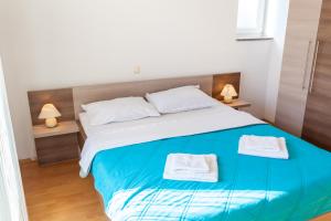 Postel nebo postele na pokoji v ubytování Apartments L&S
