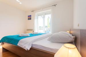 Postel nebo postele na pokoji v ubytování Apartments L&S