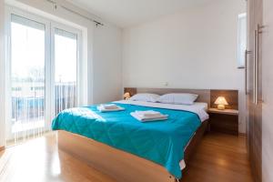Postel nebo postele na pokoji v ubytování Apartments L&S