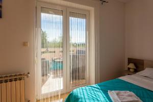 Postel nebo postele na pokoji v ubytování Apartments L&S