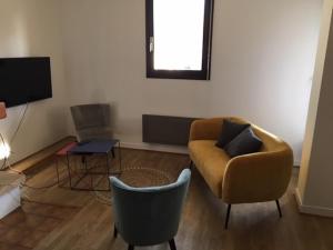 a living room with a couch and a chair at Angel Services - Le parc des Charmilles in Menthon-Saint-Bernard +7 photos