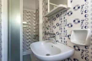 a white bathroom with a sink and a shower at Apartment Maria in Malinska +42 photos